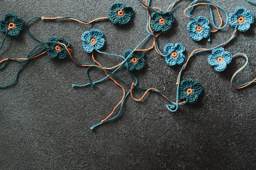 Handmade crochet blue flowers on dark background
